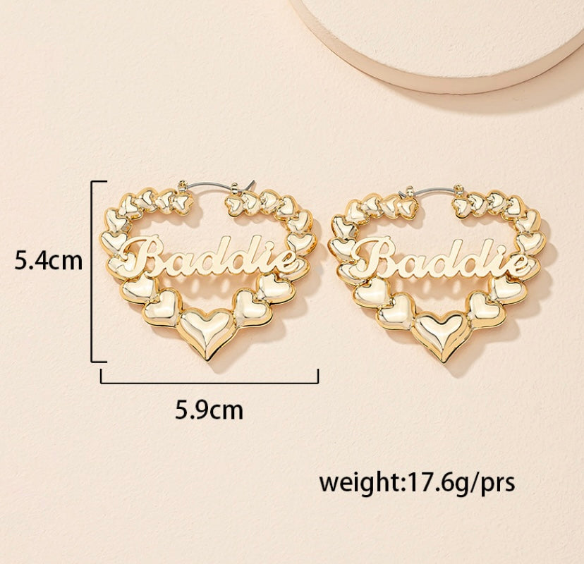 Baddie heart earrings in gold with a chic design featuring heart shapes and bold lettering