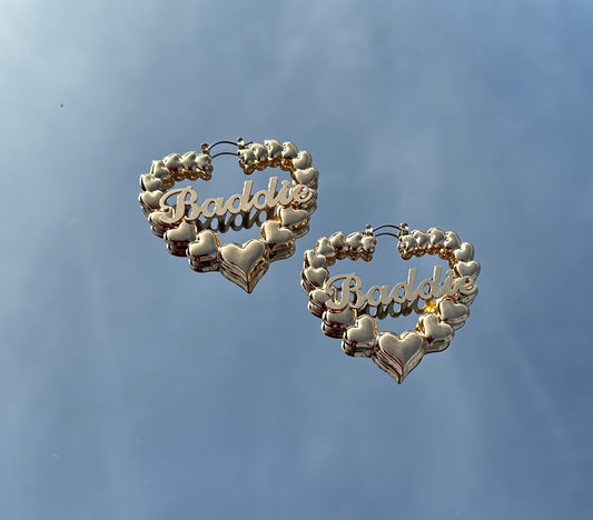 Gold baddie heart earrings featuring a heart-shaped design with the word baddie