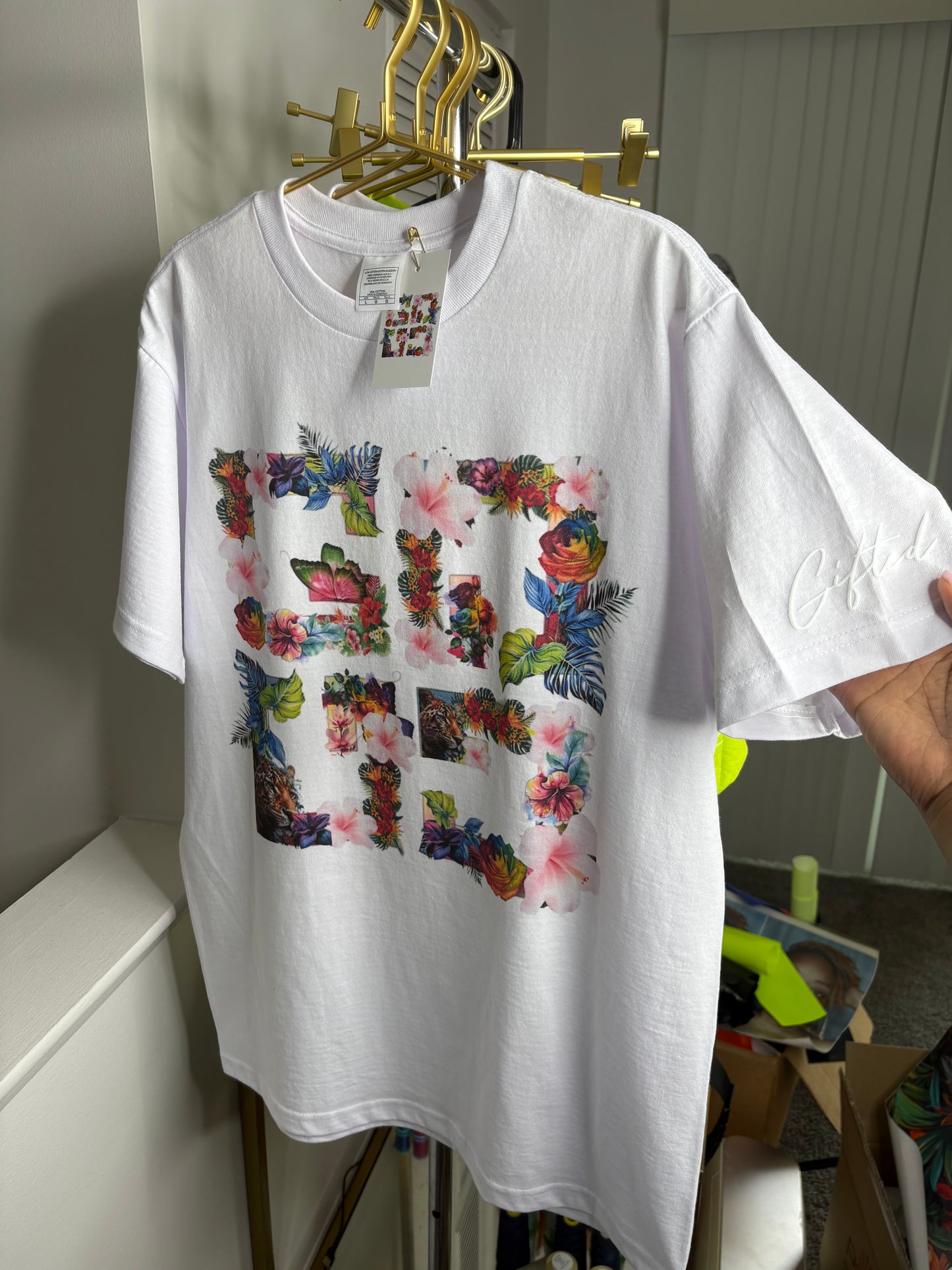 Custom floral t-shirt featuring a vibrant floral design on a white background by Gifted By Laure’alle & Co.