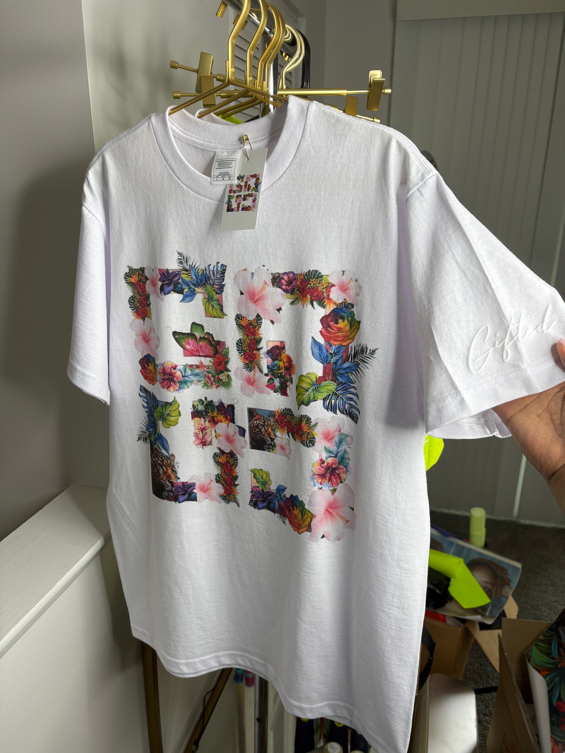 Custom floral t-shirt featuring a vibrant floral design on a white background by Gifted By Laure’alle & Co.