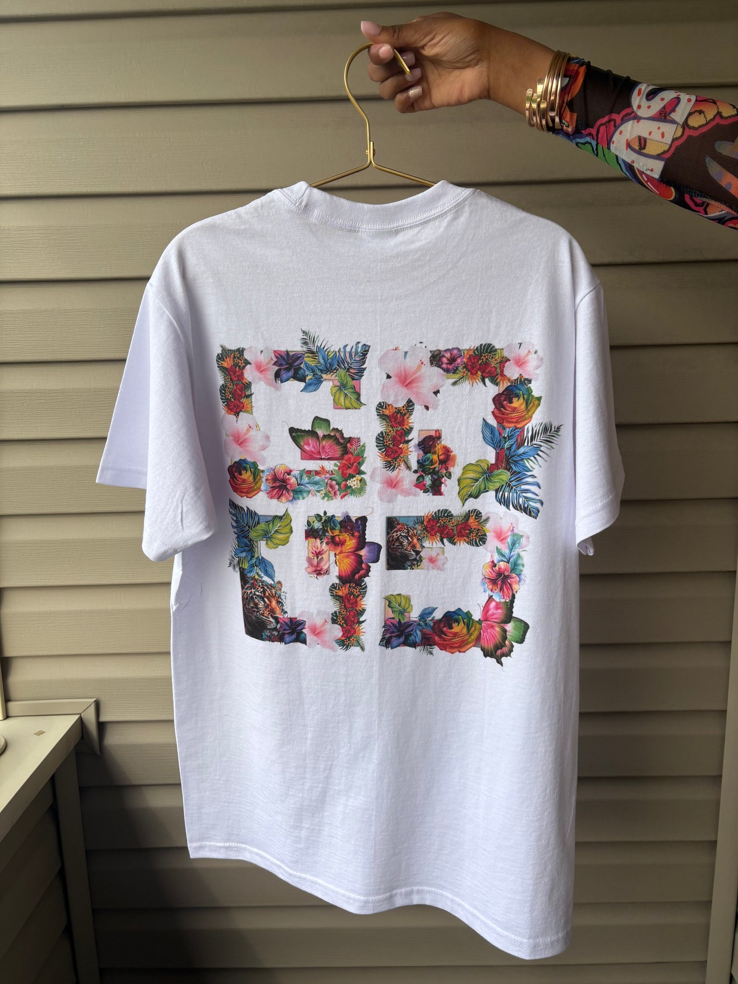 Custom floral t-shirt designed by Gifted By Laure’alle & Co. featuring vibrant floral graphics on the back