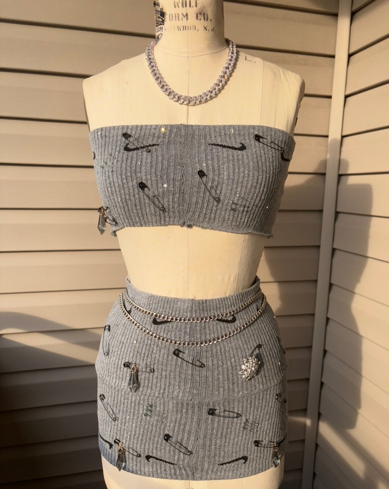 Custom Nike skirt set featuring a strapless top and fitted skirt with unique safety pin design