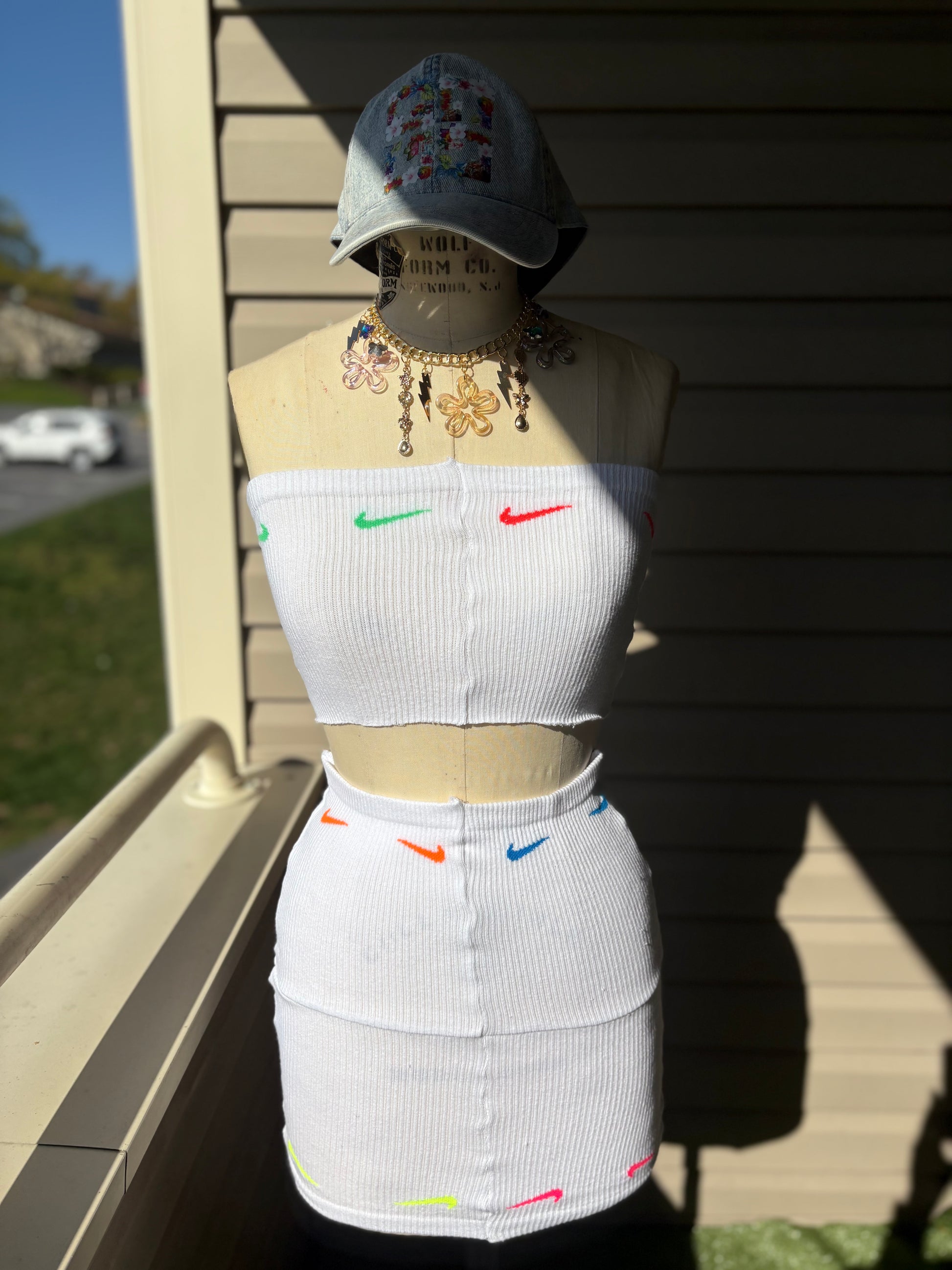 Custom white Nike skirt set featuring a cropped top and fitted skirt with colorful logo accents