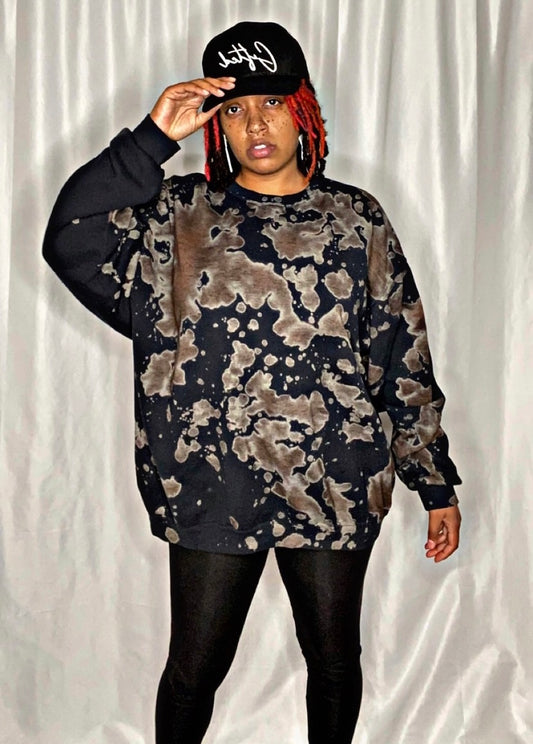 Model wearing a handmade bleached sweater in dark tones with unique tie-dye patterns